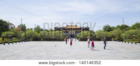 Hue, Vietnam - Jun 16, 2016: Visitors coming to see the Imperial Royal Palace of Nguyen dynasty at Ngo Mon gate. This gate is one of the forbidden city main gates leading to the central palace.