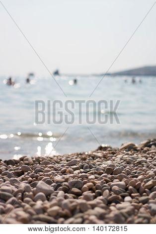 Rocks on the coast of sea. People bathe