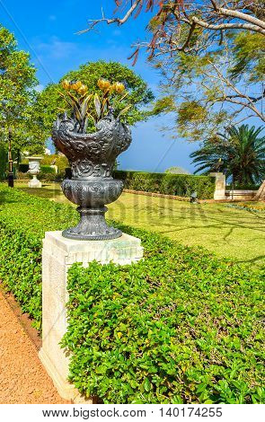 The black vase with gilt tulips in alley of Bahai Gardens Haifa Israel.