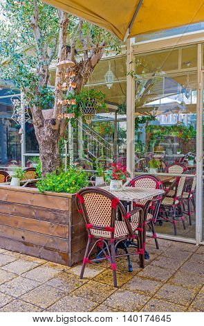 The outddor green terrace of the tavern in German Colony Haifa Israel.