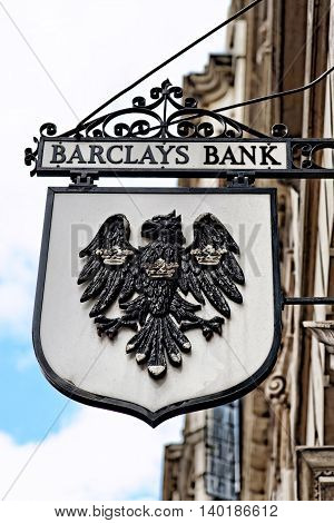 LONDON - JULY 1 2014: Vintage sign of Barclays bank branch in the City of London. Barclays was founded in 1690 and currently employs 146100 staff (2011).