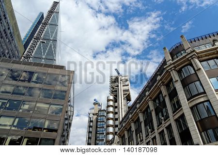 LONDON UK - JULY 1 2014: The famous office buildings - The Cheesegrater (Leadenhall Building) and the Lloyd's Building in the City of London one of the leading centers of global finance.