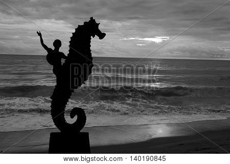 Seahorse sculpture on Los Muertos beach in sunset Puerto Vallarta Mexico. Black and white
