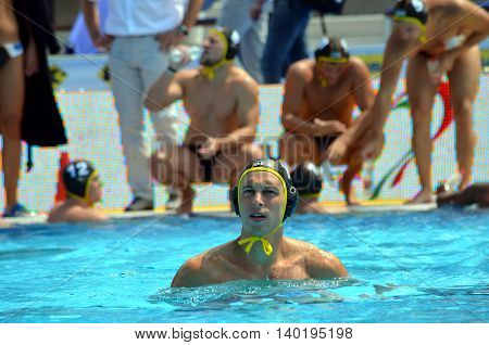Budapest Hungary - Jul 14 2014. Germany's Moritz Oeler in the focus the german team in the background. The Waterpolo European Championship was held in Alfred Hajos Swimming Centre in 2014.