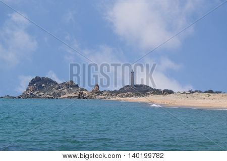 beautiful tropical beach with many rocks and historic lighthouse on small island in ke ga near muine vietnam