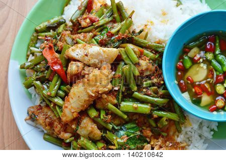 spicy stir-fried morning glory with dolly fish on rice