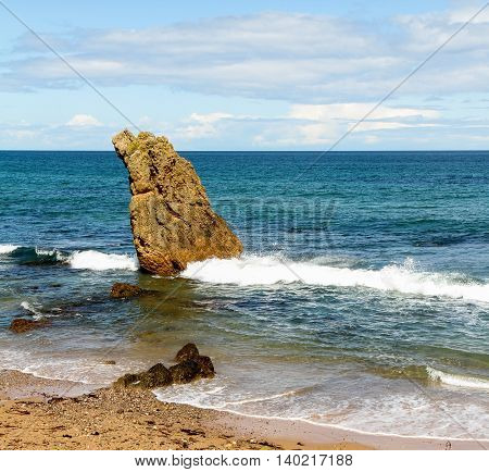 Single rock formation on Scottish beach at Cullen