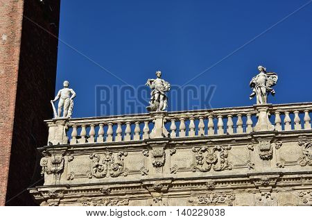 Monumental baroque balustrade of Palazzo Maffei (17th century) with greek gods statues of Jupiter Venus and Hercules in Piazza delle Erbe square in the center of Verona