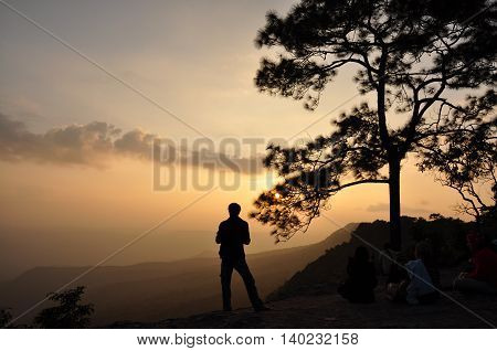 Man standing on cliff Waiting for sunset photography