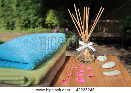 Aromatherapy Reed Difuser Bottle In A Beautiful Outdoor Setting In Morning Sunlight