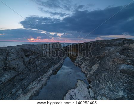 Long exposure shot on amazing pink rocks and sea