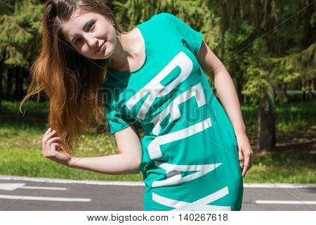 Relax girl hair straightens in the Park. Summer,