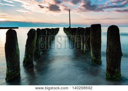 Wooden poles breaking sea water long exposure. Poland Baltic Ustronie Morskie.
