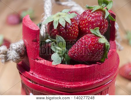 Red wooden basket full of delicious strawberries