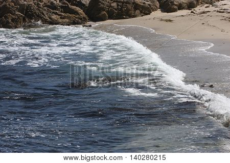 This is an image of the incoming tide taken in morning sunlight
at Point Lobos State Preserve in California, U.S.A.