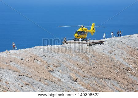 VULCANO ITALY - MAY 24: Rescue helicopter and people at top of volcano on May 24 2016 at Vulcano Island near Sicily Italy