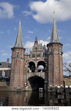 Sneek, Holland - april 6,2013: The famous watergate in sneek and people in the background.