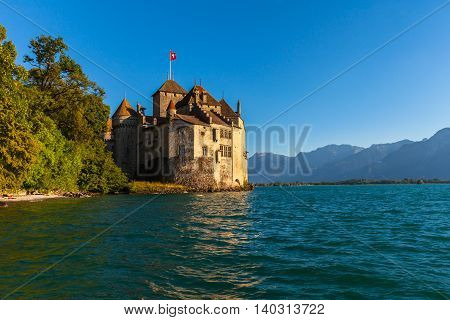 Beautiful view of Chillon castle at dusk in the golden sunshine on the lakeside of Lake Geneva Montreux Canton of Vaud Switzerland