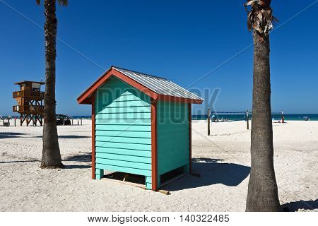 A colorful beach bath house on the sandy public beach area