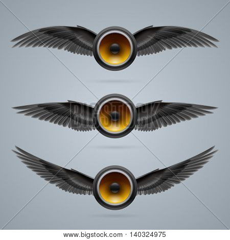 Three music speakers with two crow wings each.