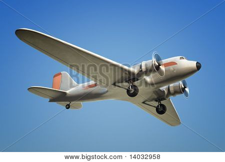 Et skud af et DC3 fly i flugt mod en blå himmel