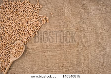 Dried white chickpeas ceci on sack. Top view.