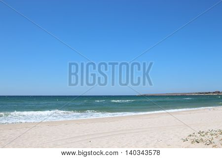 Sea view from the sandy beach during the day