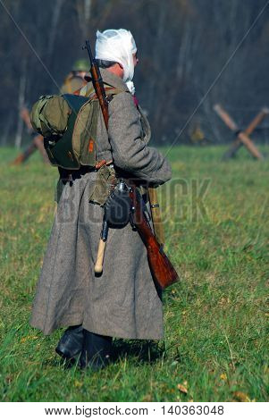 MOSCOW REGION - OCTOBER 13, 2013: Reenactor dressed as WW II soldier. The battle he is reenacting was the Moscow Battle held in 1941.
