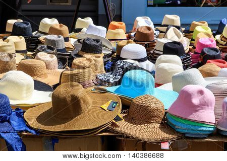 Variety of sun hats displayed in a street market