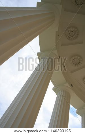 White pillars of ancient european museum with blue sky on background