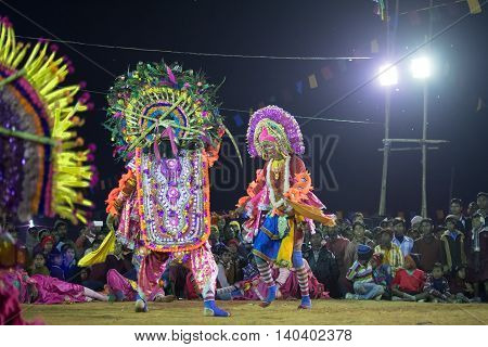 BAMNIA PURULIA WEST BENGAL INDIA - DECEMBER 23RD 2015 : Dancer dressed as Hanumanji is killing monster Chhau Dance festival. It is a very popular Indian tribal martial dance performed at night amongst spectators.