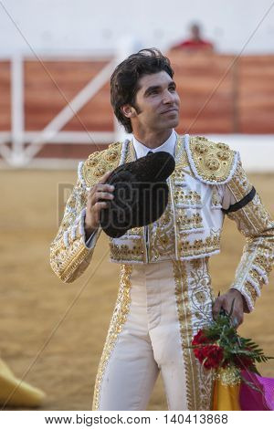 Sabiote SPAIN September 9 2011: The Spanish Bullfighter Cayetano Rivera to the turning of honour with an ear in his hand in the Bullring of Sabiote Spain