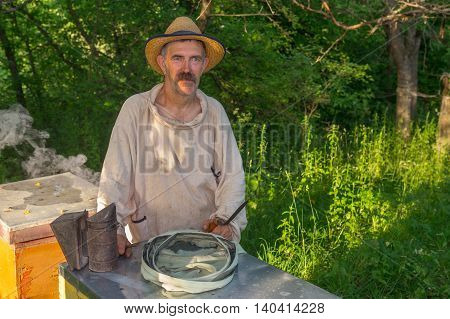 Portrait of Ukrainian bee-keeper on his apiary