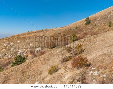 Autumnal landscape with hiking path on a mountain pasture Demerdzhi Crimean peninsula