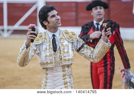 Sabiote SPAIN September 9 2011: The Spanish Bullfighter Cayetano Rivera to the turning of honour with an ear in his hand in the Bullring of Sabiote Spain