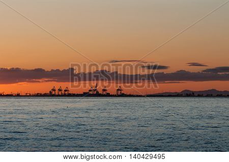 Sun dawn over the cranes from Point Roberts Washington State USA