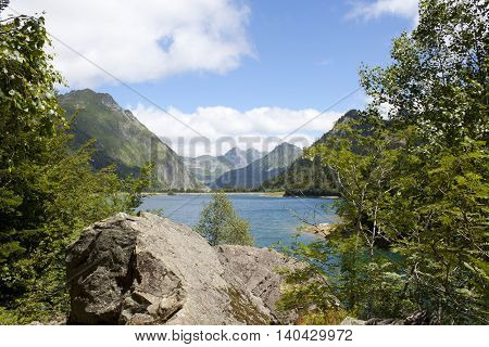 Stones And A Lake Between Mountains In The Ayous Lakes, Pyrenees, France