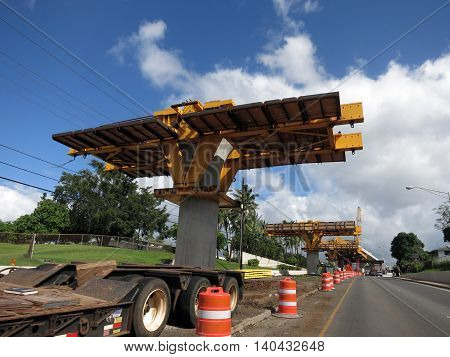 HONOLULU - NOVEMBER 29: HART Light Rail concrete guideway under construction in road center in Pearlrigde on Oahu Hawaii on November 29 2015. HART is building a 8 billlion dollar railway linking Oahu communities.