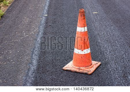Road construction cones on an asphalt surface.