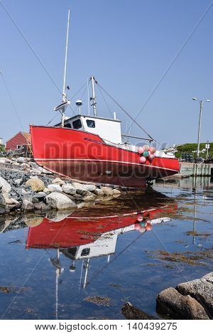 Old fishing boad has run aground on the rocks