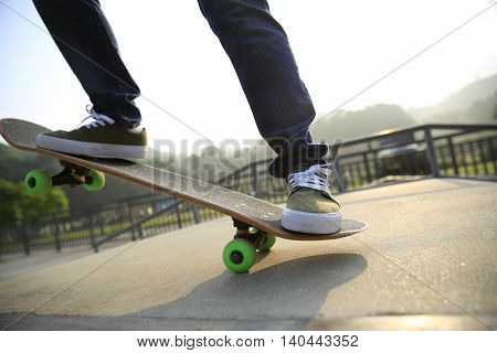 one young skateborder skateboarding at skatepark ramp