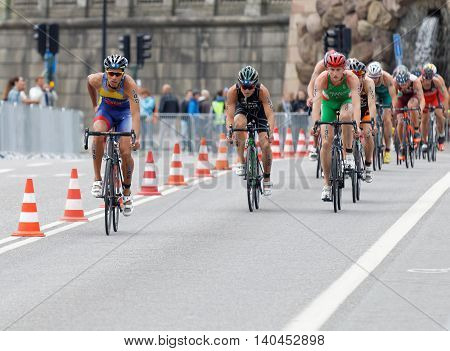 STOCKHOLM SWEDEN - JUL 02 2016: Group of colorful male triathlete cyclists Benjamin Shaw (AUS) and competitors in the Men's ITU World Triathlon series event July 02 2016 in Stockholm Sweden