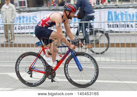 STOCKHOLM SWEDEN - JUL 02 2016: Side view of male triathlete cyclist Adam Bowden in the Men's ITU World Triathlon series event July 02 2016 in Stockholm Sweden