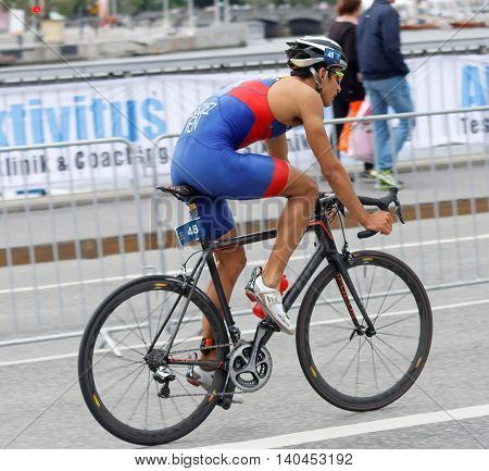 STOCKHOLM SWEDEN - JUL 02 2016: Side view of male triathlete cyclist Luis Miguel Velasques in the Men's ITU World Triathlon series event July 02 2016 in Stockholm Sweden