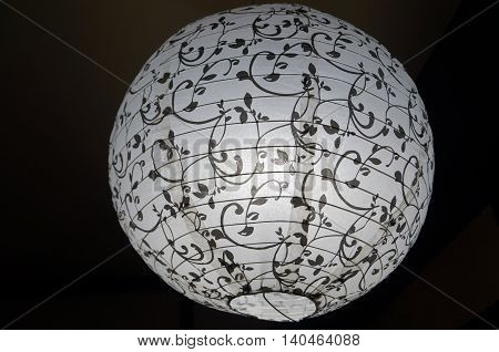 Lamp shade decorated with white paper with black pattern