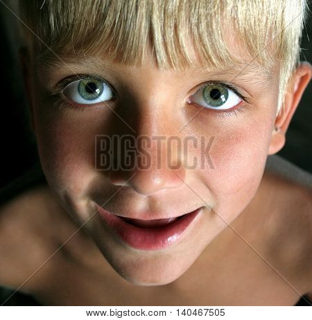 Happy boy close up portrait. Boy opened mouth and smiling