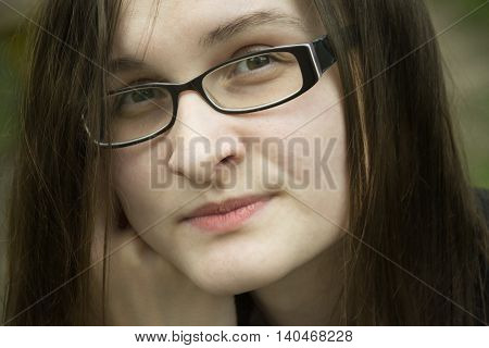 Beautiful woman in glasses portrait. Office woman thinks about something