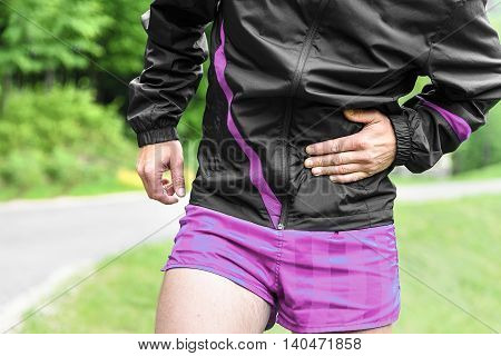 Man runner side cramps after running outdoors