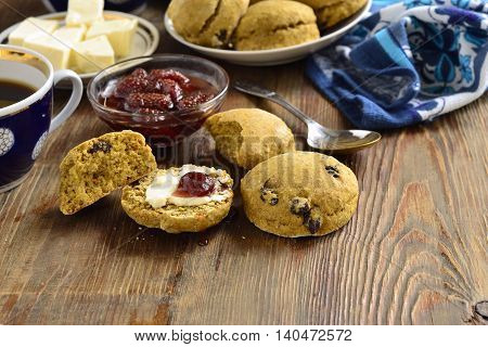 Pumpkin scones with dried fruit for breakfast served with jam and butter