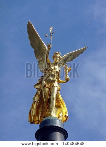 Famous golden statue Friedensengel (angel of peace) in Munich Germany that is standing on a column and watches over the city